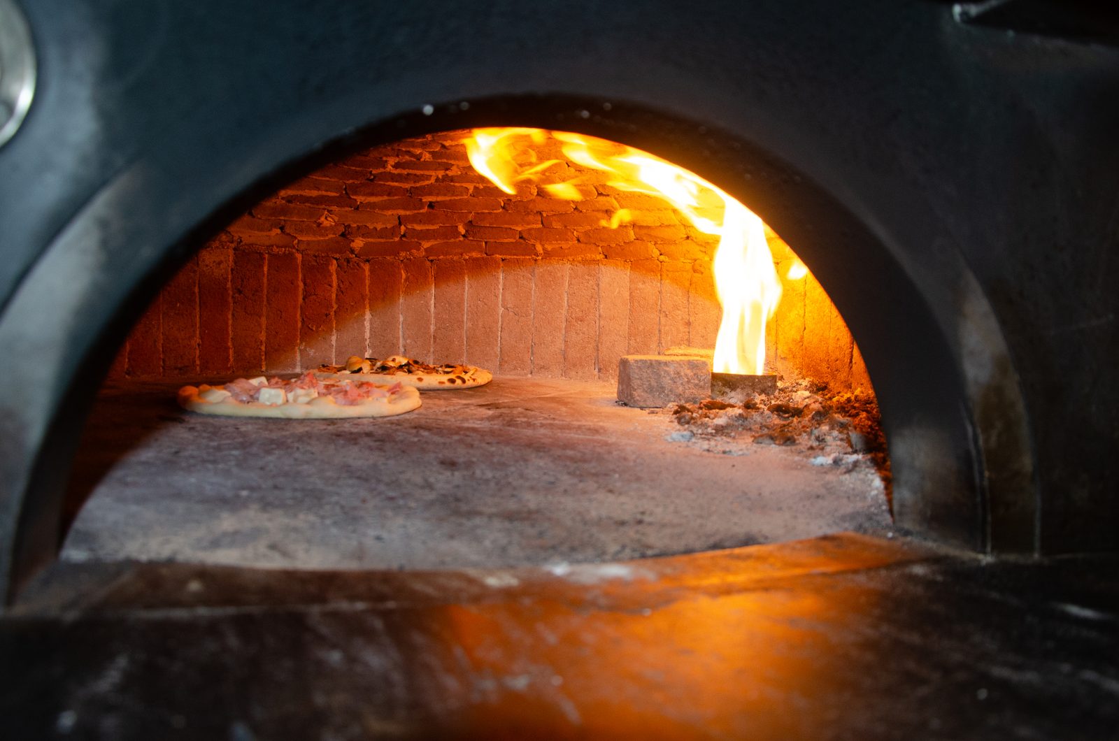Pizzas baking in the wood-fired oven at Pizza on Fire